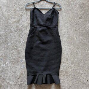 Black bodycon dress with zipper back, ruffle hem and mesh details